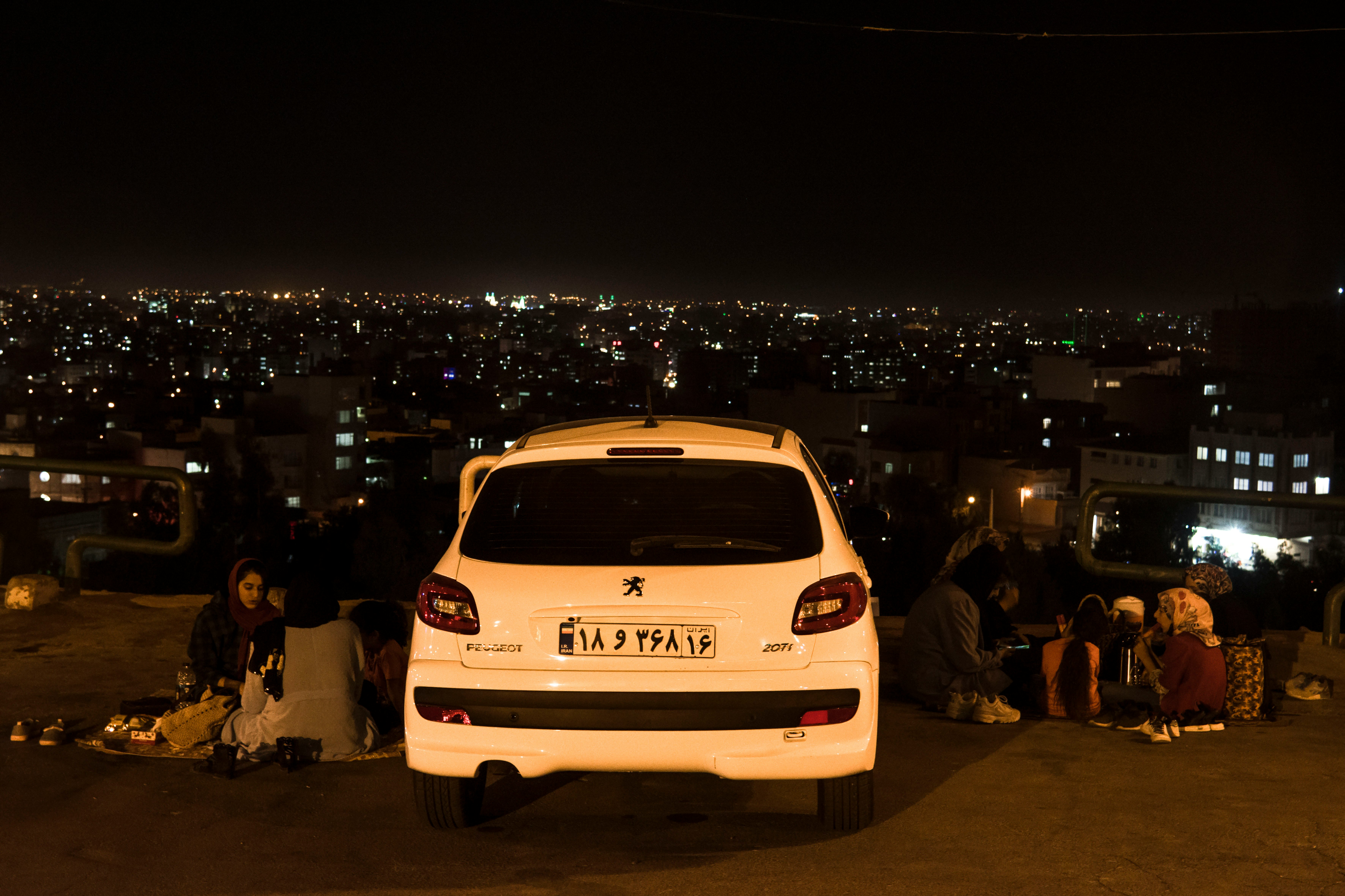 white car on road during night time